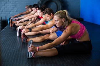Side view of athletes stretching in gym.jpeg
